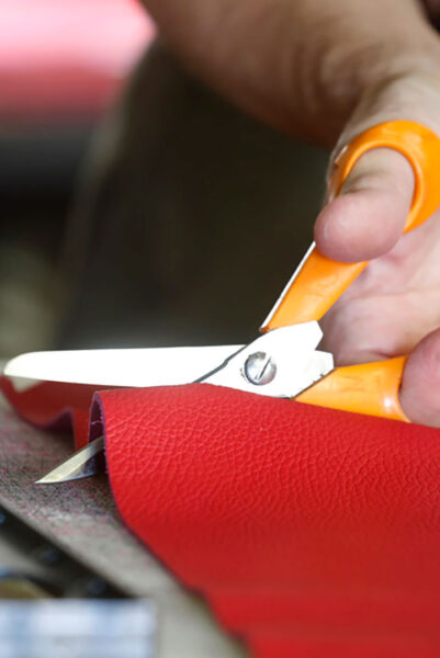 Cutting raw materials with a scissors.
